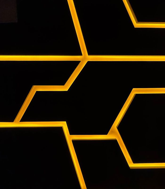 Abstract digital glowing geometric patterns in dark space